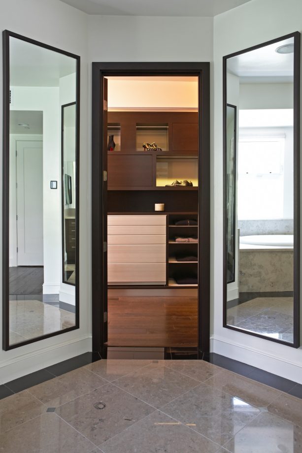 walk-in closet door with tall mirrors on both sides