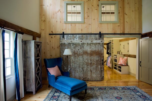 walk-in closet with a weathered farmhouse style barn door