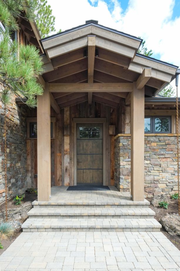 weathered wood front door in brown color to create a mountain style