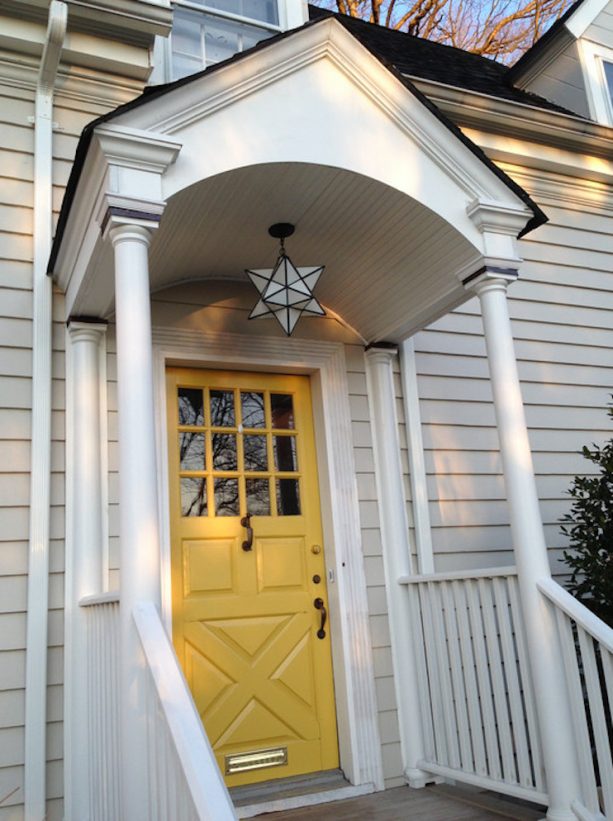 yellow wooden front door around beige walls