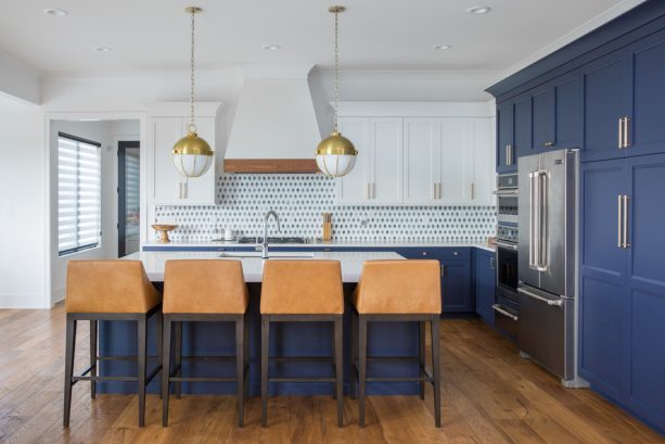benjamin moore - hale navy lower cabinets and sherwin williams - pure white upper cabinets in a beach style kitchen