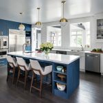 benjamin moore - van deusen blue tall cabinetry and island paired with benjamin moore - chantilly lace white kitchen cabinets for a mid-century look