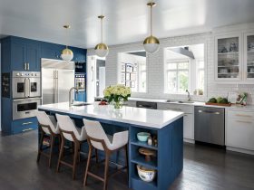 benjamin moore - van deusen blue tall cabinetry and island paired with benjamin moore - chantilly lace white kitchen cabinets for a mid-century look