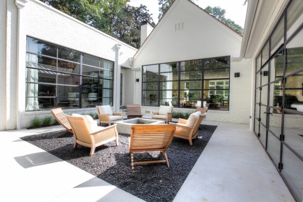 black pea gravel area with a concrete fire pit that matches the surrounding