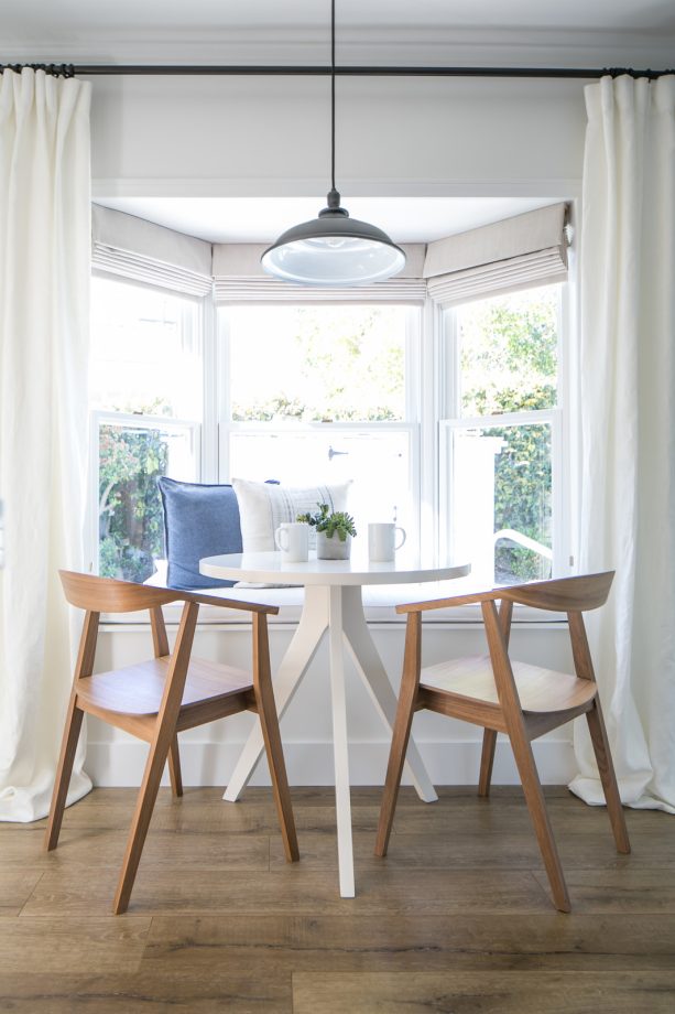breakfast nook in the bay window with a curtain to separate the nook and the dining space