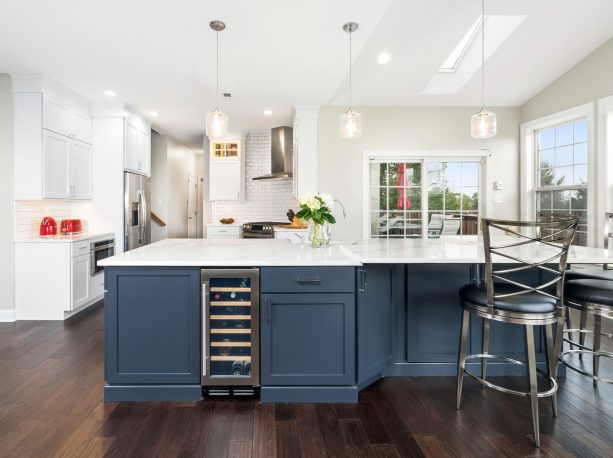 charcoal blue island cabinetry to contrast the white perimeter cabinets and backsplash