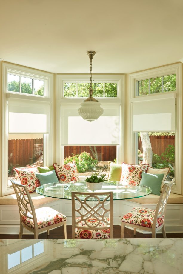 cheerful cushion with floral pattern in a window bay breakfast nook