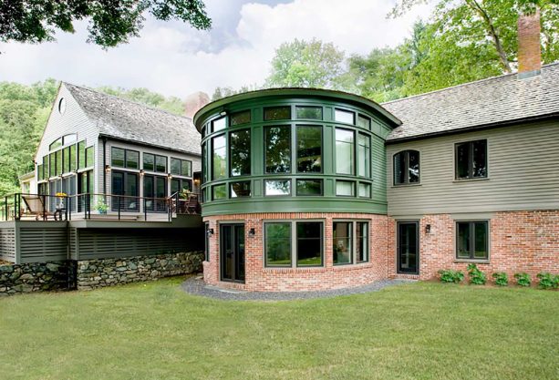 combining green and brick siding to create a unique house