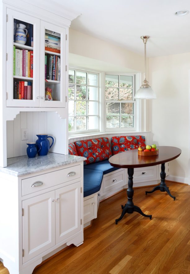 comfy bench with a cushion and no additional chairs in a window bay breakfast nook