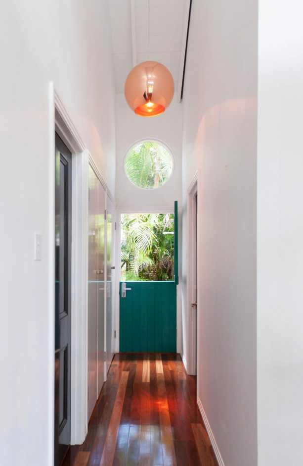 contemporary hallway with a dutch door painted in resene sea green