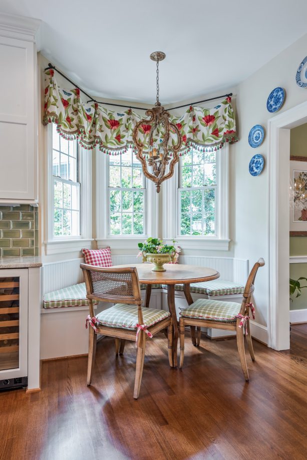 cottage style breakfast nook in a bay window with green and floral pattern valance