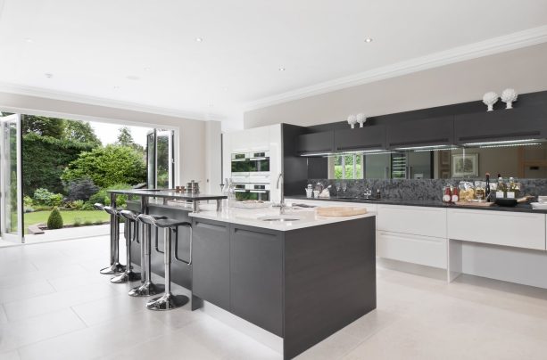 dark gray cabinets and island paired with crisp white countertops