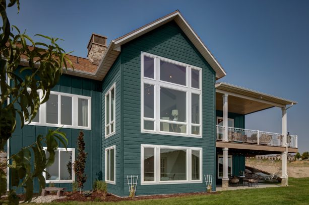 dark green siding combined with a caramel-colored shingled roof