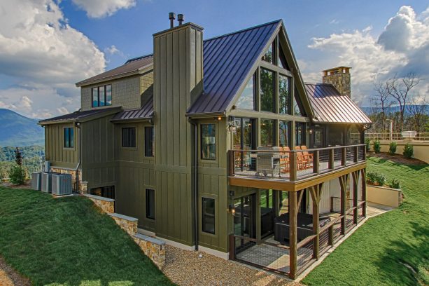 dark olive green siding counteracted by glass element to brighten up the house