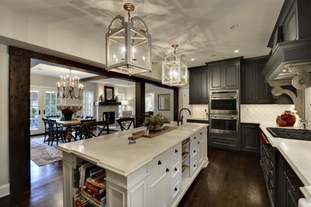 dark wood floor and dark gray cabinets in a traditional kitchen