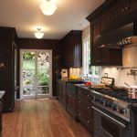 elegant kitchen with dark brown cabinets stained in “peppercorn” and made of lyptus wood