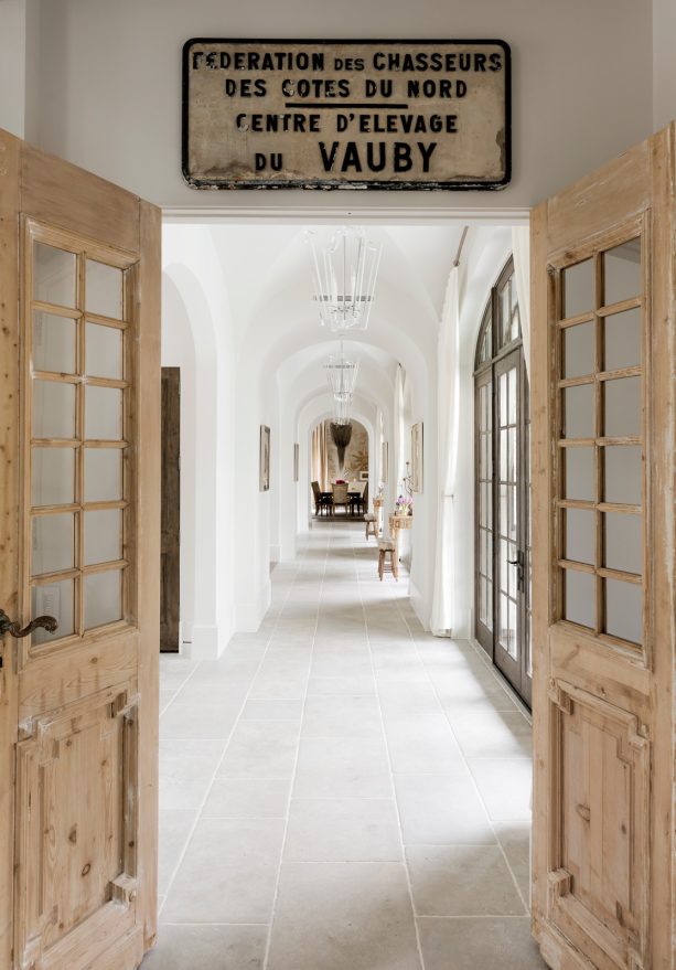 glass panel with wooden framed door in a white mediterranean hallway