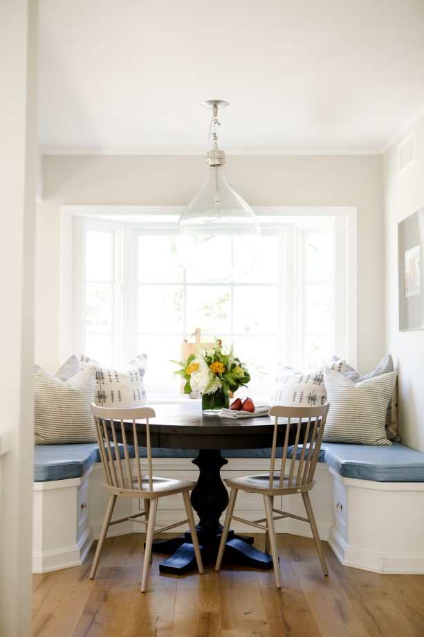 incorporating light blue and white color scheme in a bay window breakfast nook