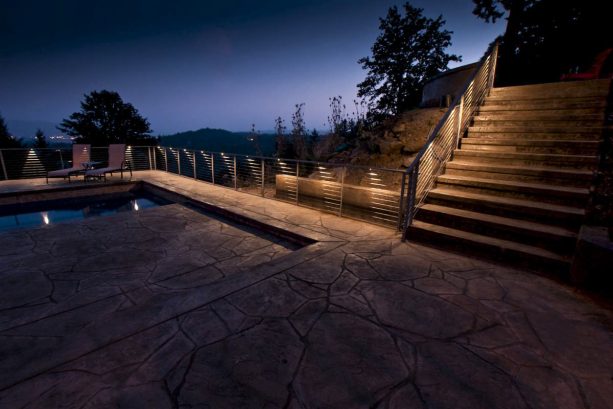 led accent lights spaced along the railing of the outdoor fence