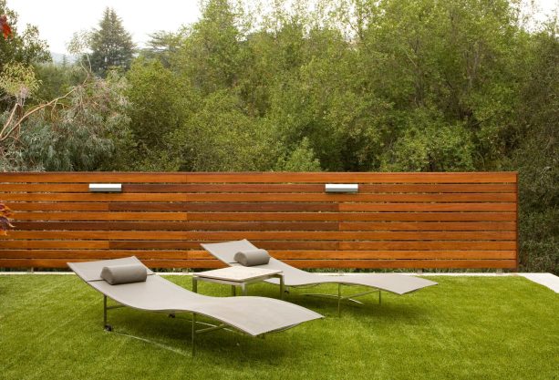 linear light fixtures on the fence to illuminate the outdoor area