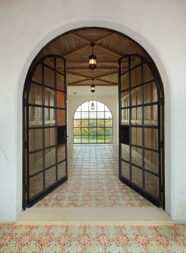 mediterranean hallway ideas with double glass front door and ceramic tile