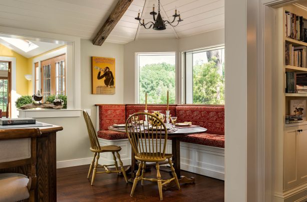 red cushion in a built-in bench of a bay window breakfast nook