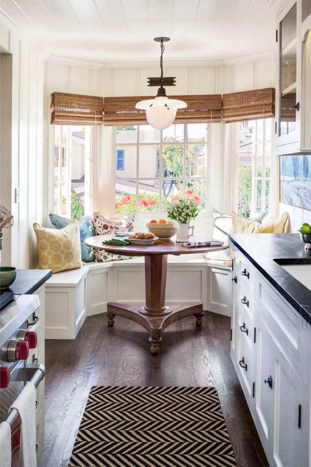 small traditional breakfast nook in a bay window with a woven shade treatment