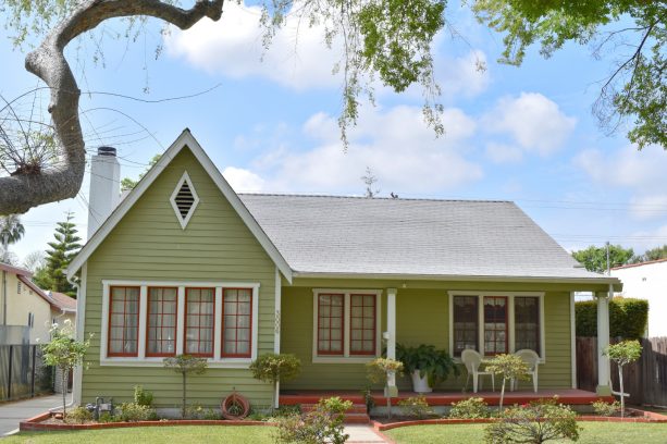 soft green siding complemented by reddish brown trim in an arts and crafts house