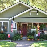 spanish moss green siding house exterior paired with black and white trim