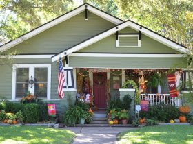 spanish moss green siding house exterior paired with black and white trim