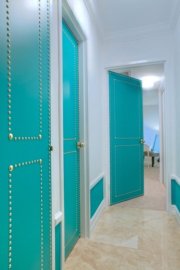 studded turquoise hallway door to create an eclectic look