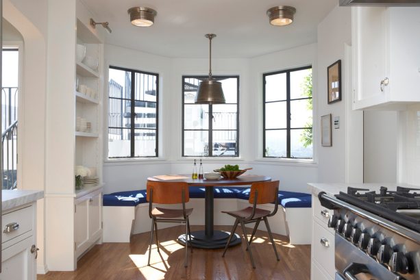 transitional breakfast nook with modern style bay window and classic chairs and table