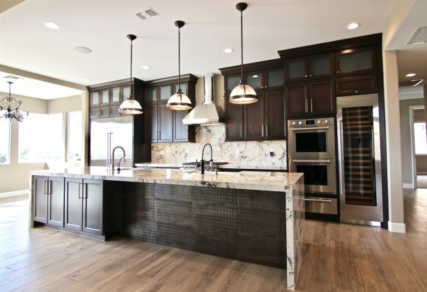 transitional kitchen with dark brown cabinets and stone slab backsplash