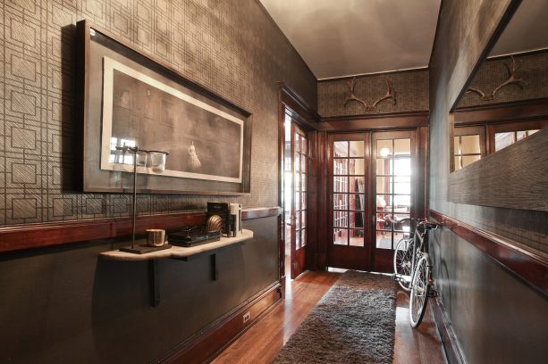 trendy hallway idea with wood framed glass panel doors combined with gray walls