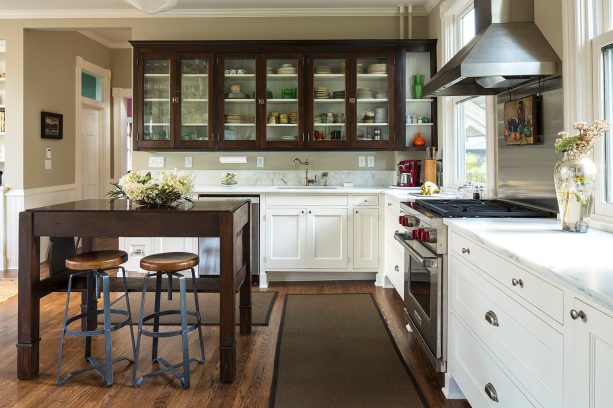 two-tone kitchen cabinetry with dark brown glass front upper cabinet