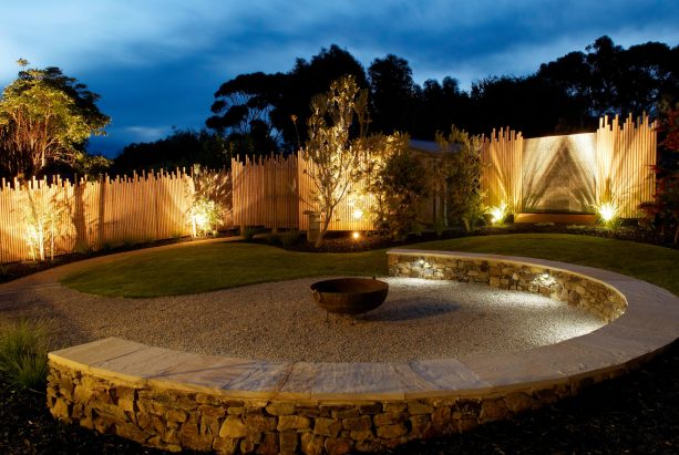 uplight below the fence to create a dramatic lit outdoor