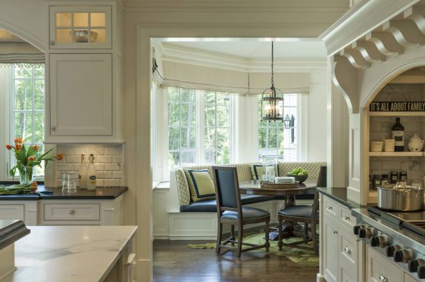 white breakfast nook with white roman shade window treatment