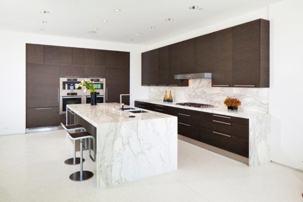 white super sleek kitchen with dark brown cabinets as an accent
