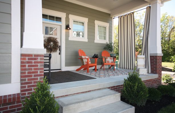 adding rugs to decorate the concrete front porch
