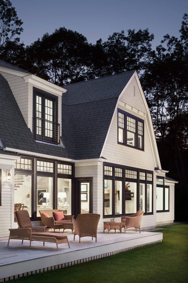 black and white color for the roof and window exterior trim in a beige beach-style house
