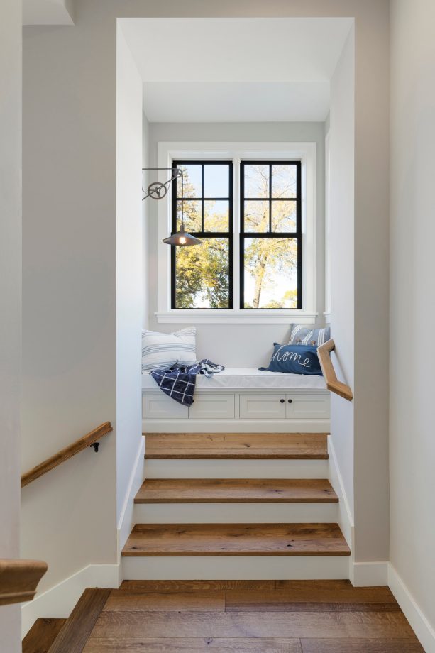 black and white window and trim in a beach-style staircase with a wood element as an accent