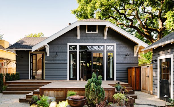 black decorative transom and sidelight windows framed by white trim in a craftsman's house