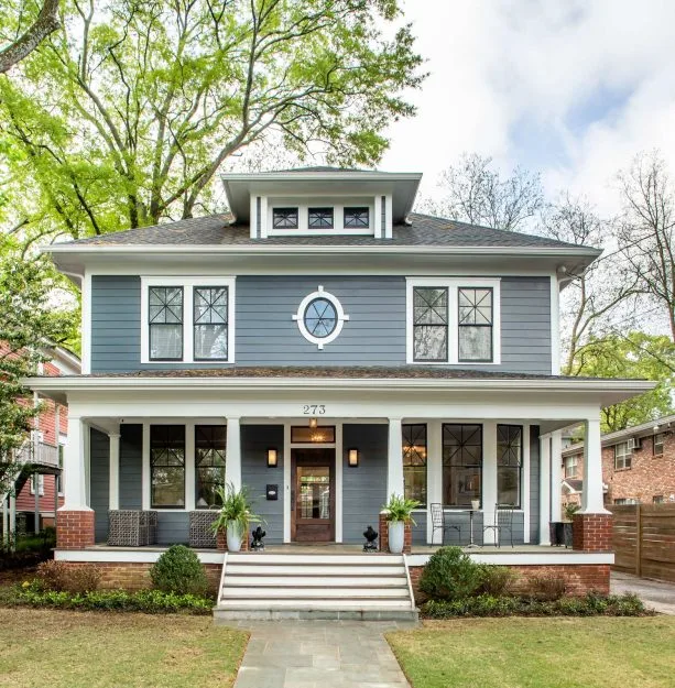 black double hung windows with white trim and columns in a traditional exterior