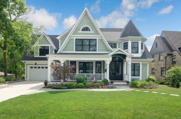 black windsor windows with white trim combined with soft green siding