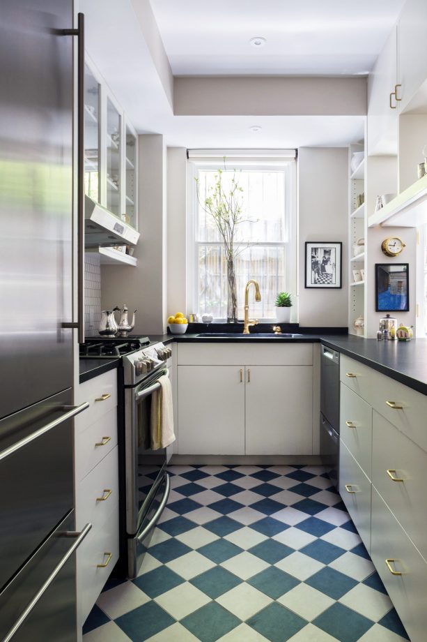 blue and white porcelain floor tile in a diamond pattern to create a calming look against the white cabinets