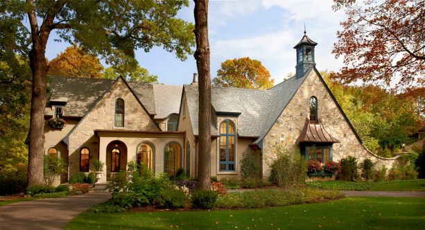 blue exterior trim as a pop of color in a french country beige house