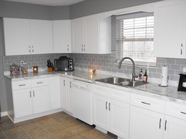 calacatta marble laminate countertop with aegean edge and gray subway tile backsplash