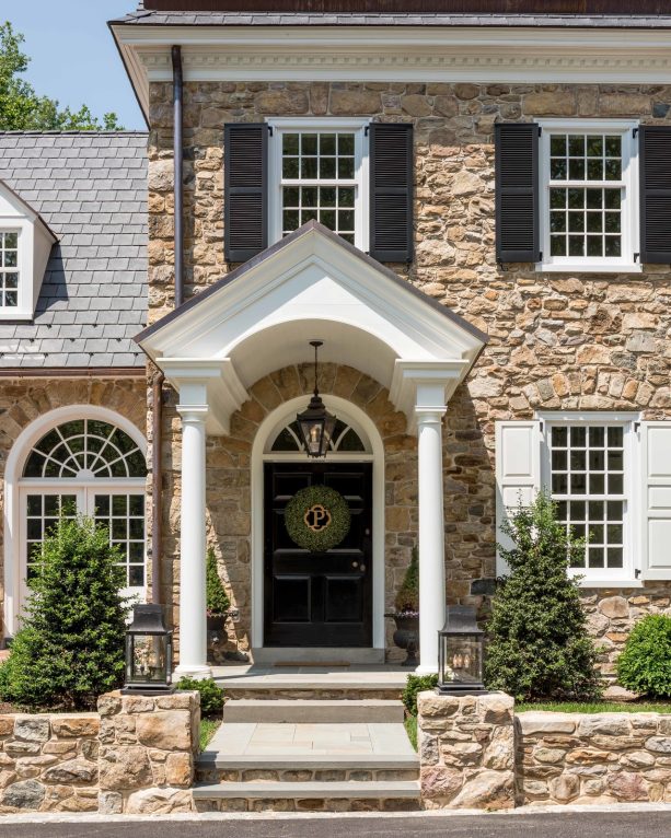 classic entrance with a portico and arched front door