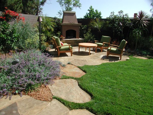 contemporary landscaping with a dark stained corner fence to enclose a fire pit patio