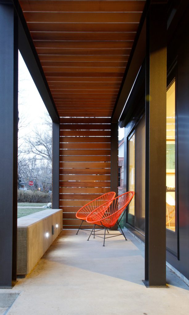 creating a contrast between the furniture and the color scheme of the concrete front porch